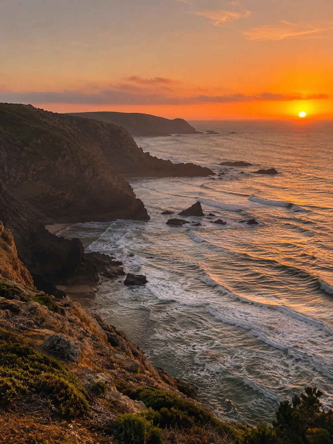Sunset over a rocky coastline