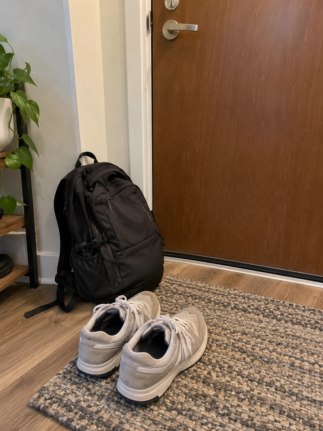 Backpack and trainers by a front door